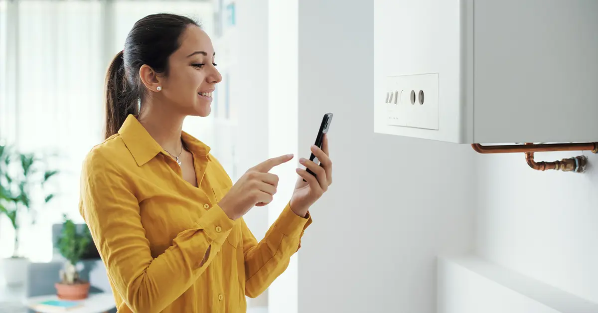 Commercial gas engineer checks device near gas boiler