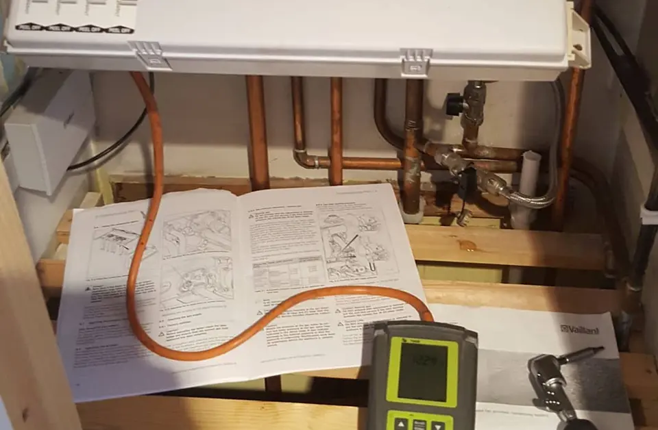 Gas engineering tools and manual on a workbench