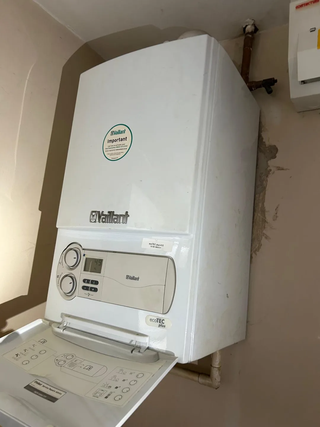 Vaillant boiler with its control panel flap open, showing the timer and controls