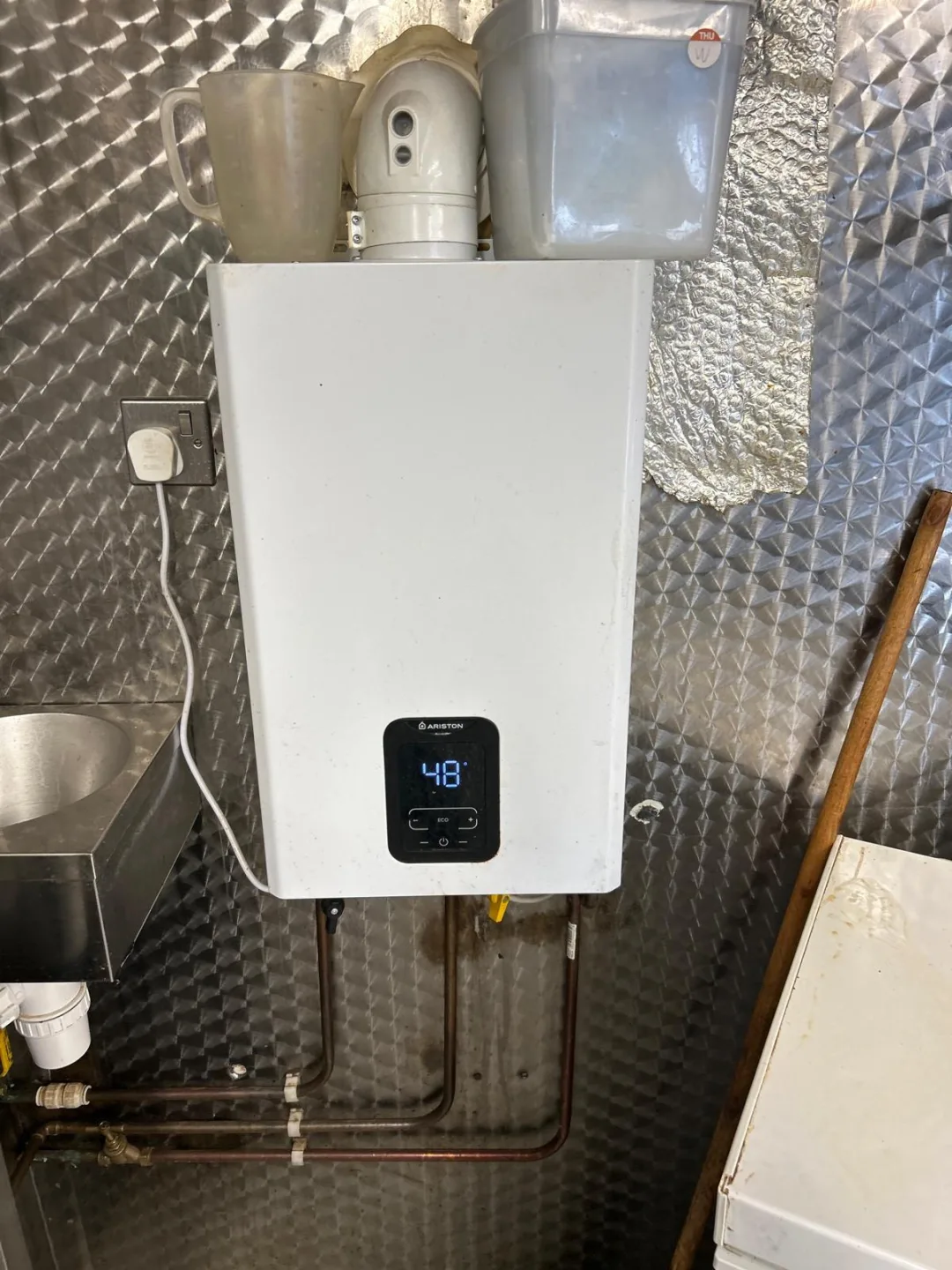Modern boiler showing a 48 degree flow temperature on its digital display