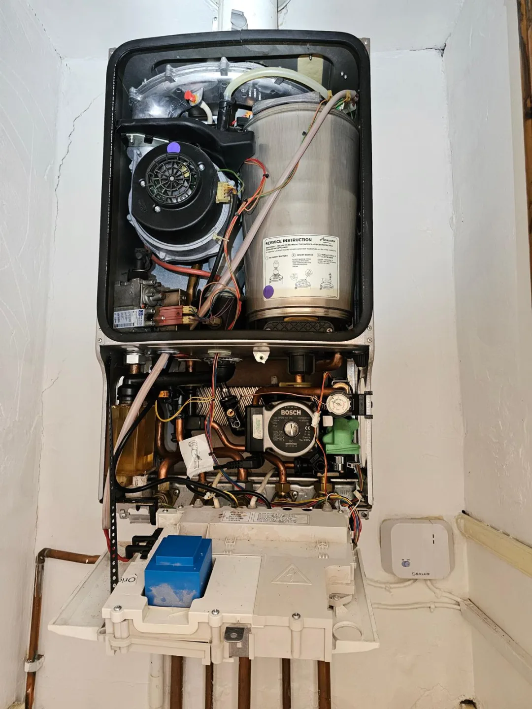 Boiler stripped down for service with the fan, burner and pump exposed