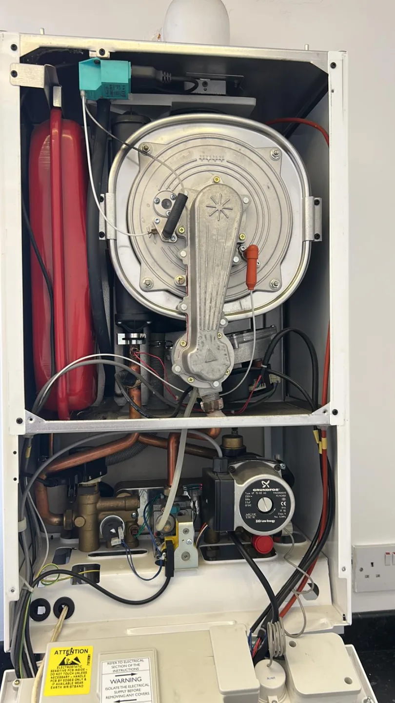 Open boiler showing the heat exchanger, circulating pump and expansion vessel