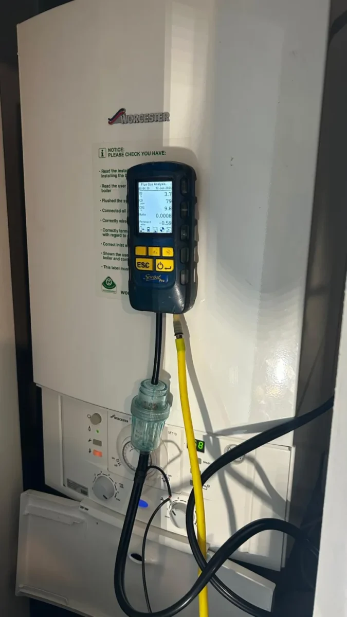 Flue gas analyser connected to a Worcester boiler, sampling hose fitted to the flue test point