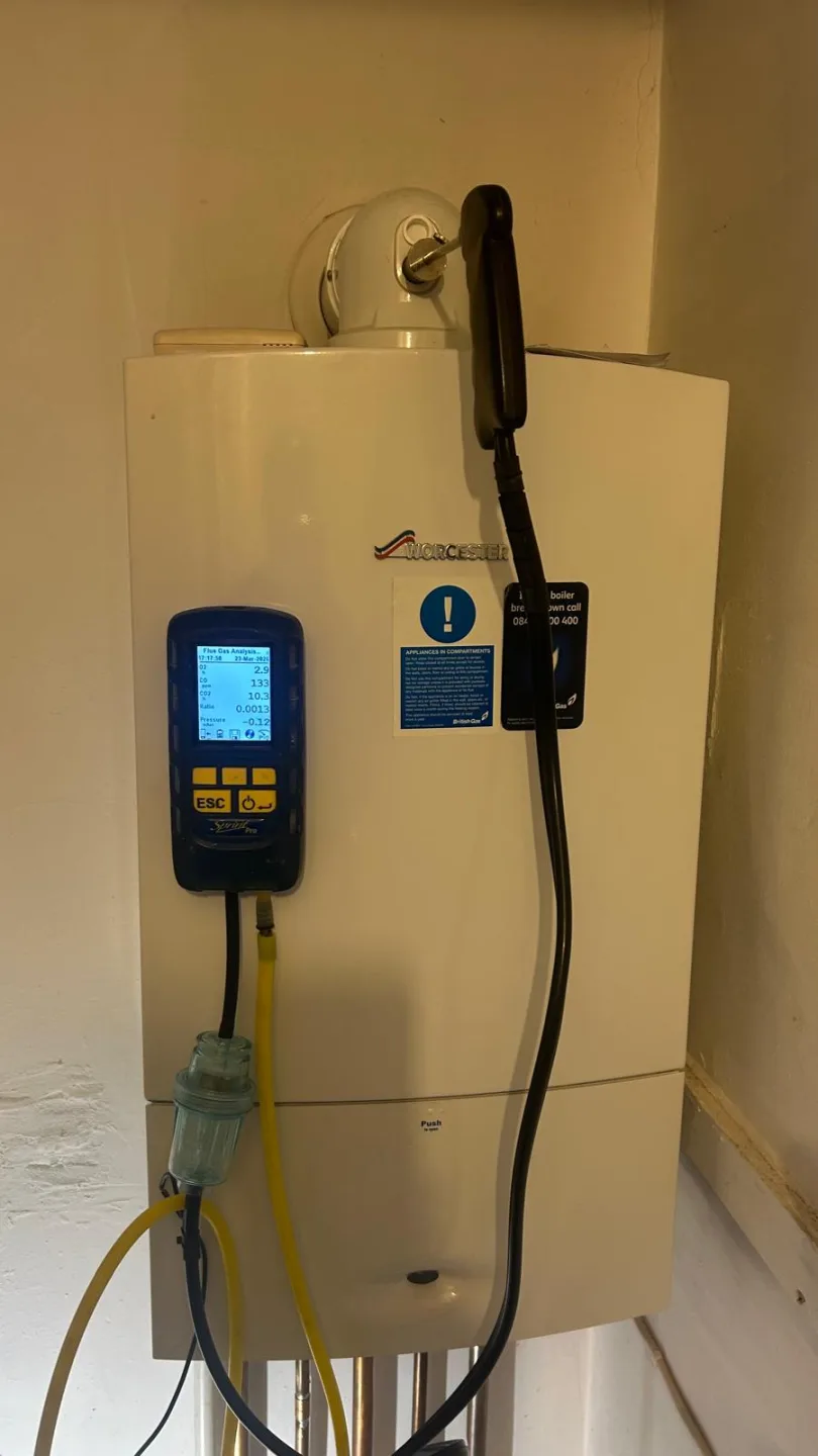 Worcester boiler under test with the analyser connected and its hose to the flue