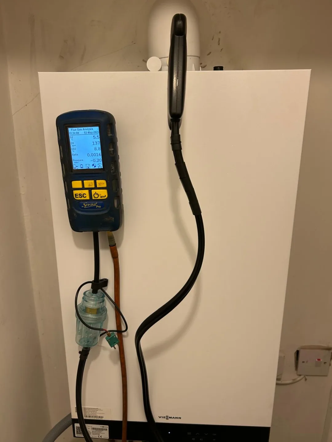 Viessmann boiler under test with the analyser connected to the flue