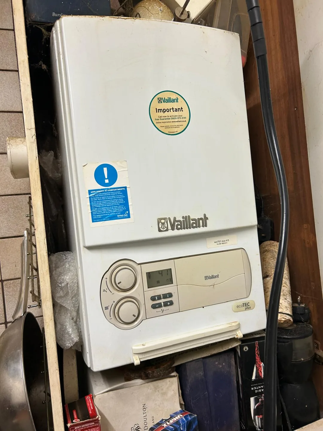 Vaillant boiler mounted above storage shelving in a domestic utility space