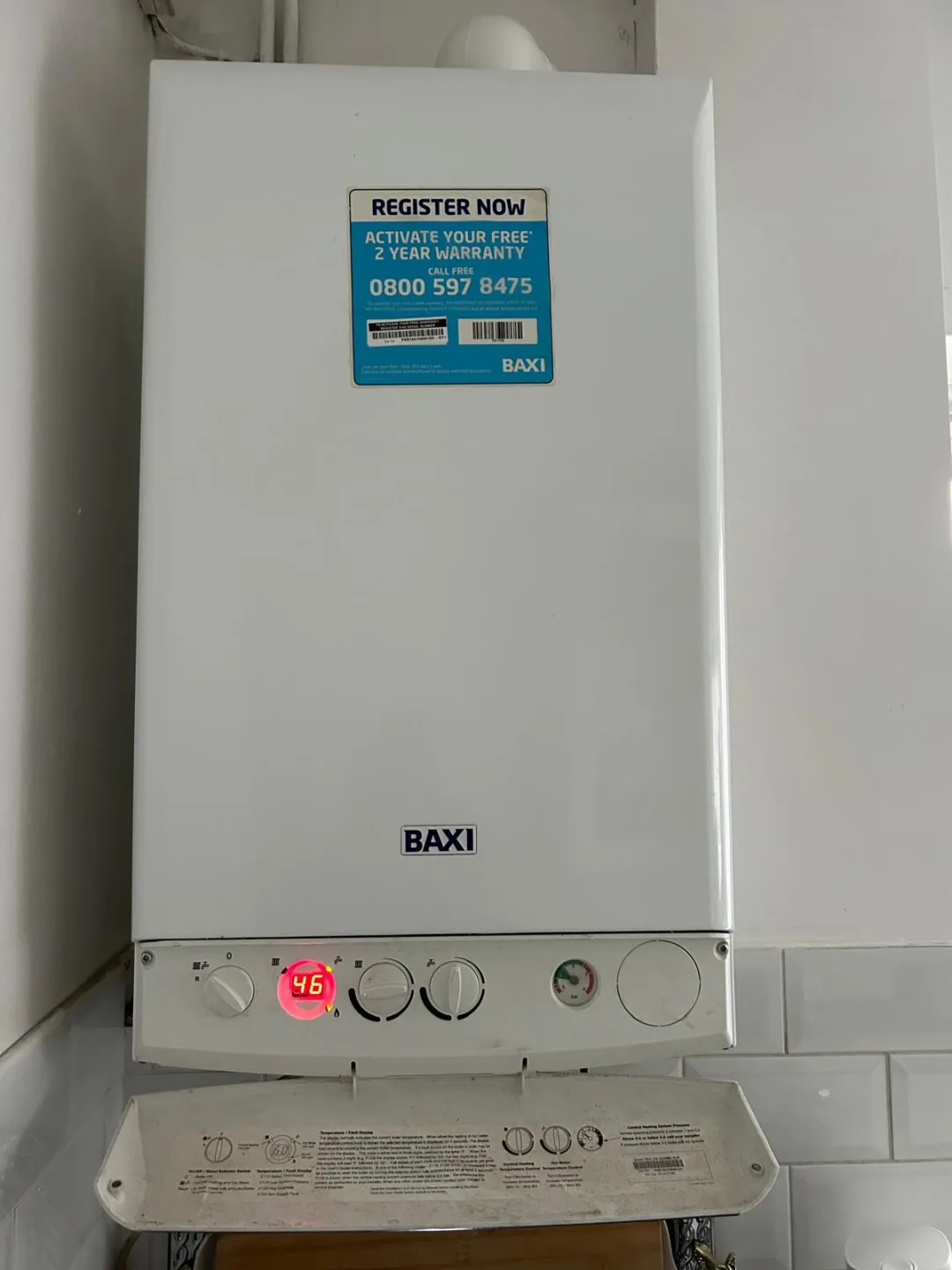 Baxi combi boiler showing its temperature display above a tiled splashback