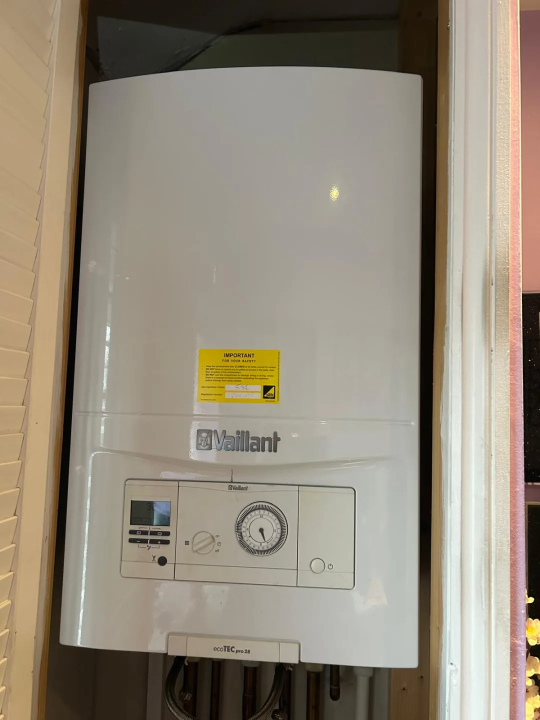 Vaillant boiler with a mechanical timer, mounted beside a doorway